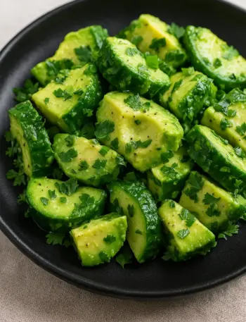 Easy Cucumber Avocado Salad | Ready in 10 Minutes Bowl of Cucumber Avocado Salad with fresh parsley sprinkled on top.