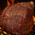 Juicy Traeger smoked prime rib roast with herb crust on a Traeger pellet grill, ideal for festive holiday dinners.